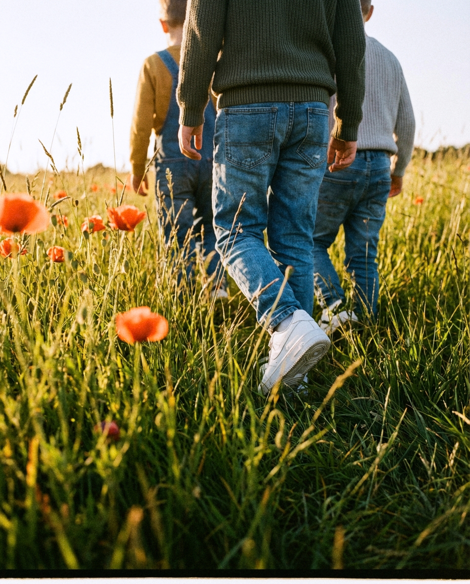 Kids walking through poppy field in Grove Footwear