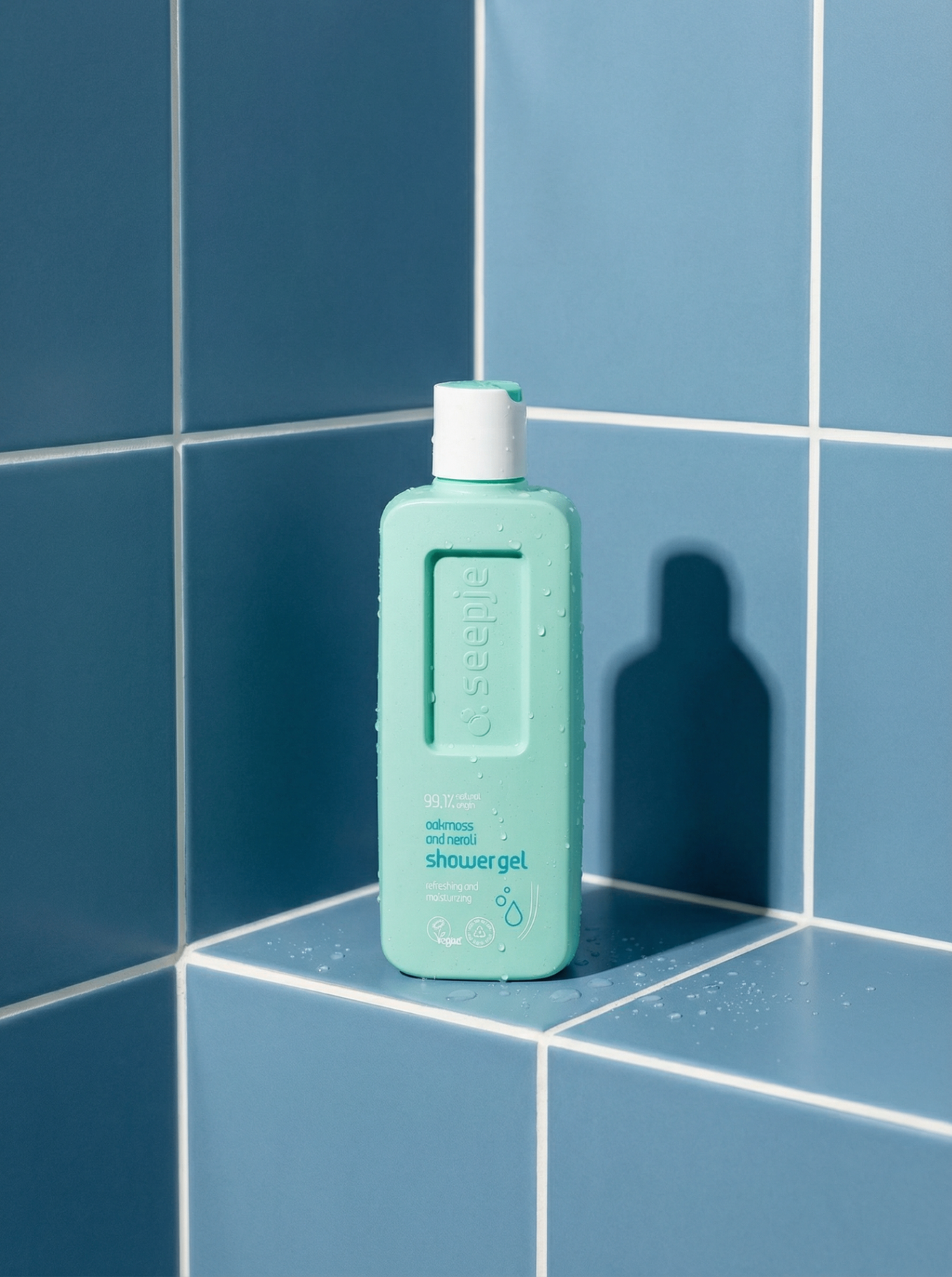 Oakmoss shower gel on blue tiles